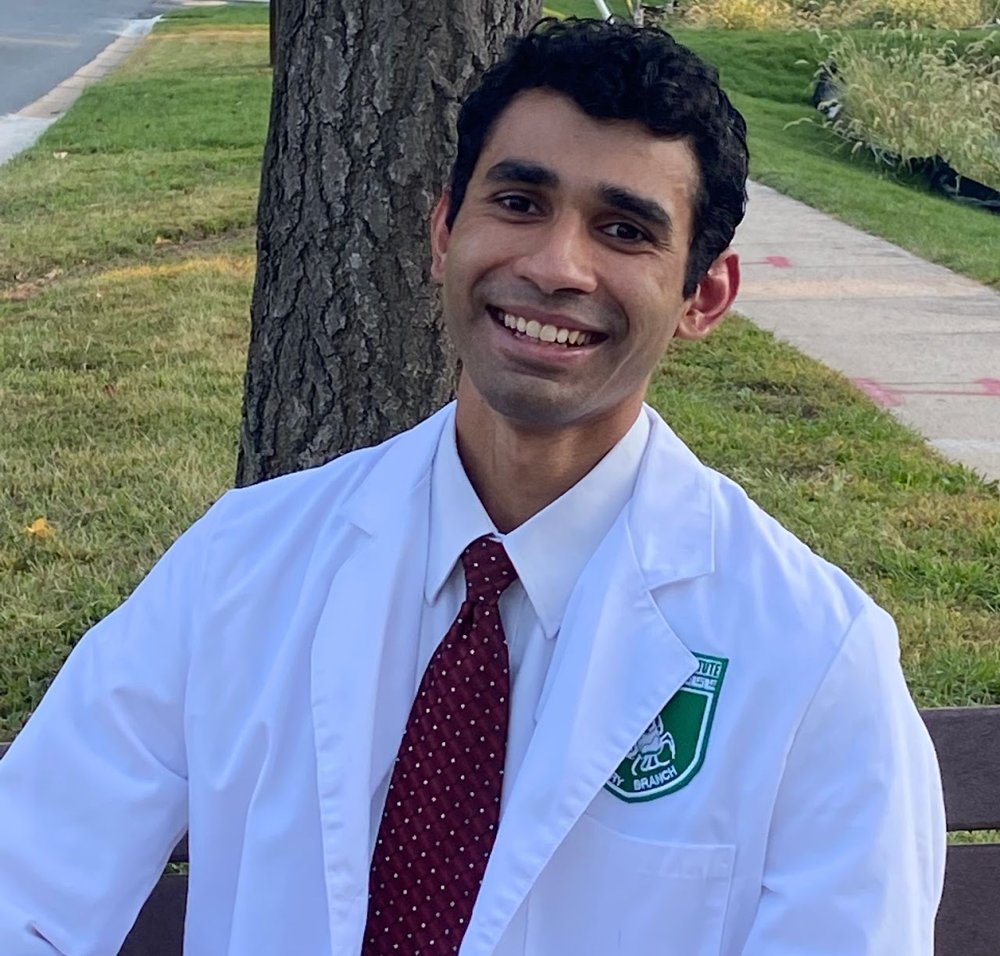 Lutfi Huq in a white coat, smiling